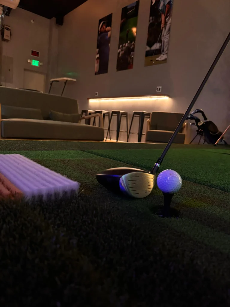 Indoor golf simulator setup at The Bunker BVI in Tortola with driver and ball ready for play